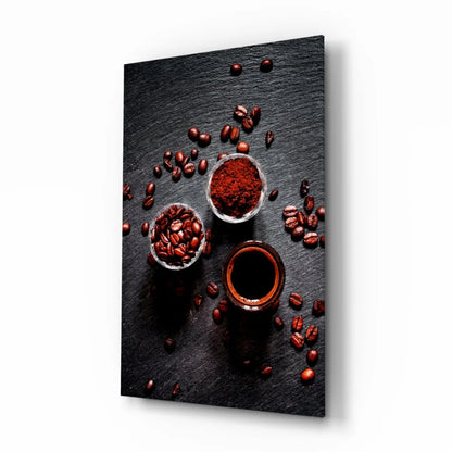 Black slate glass wall art with coffee beans, grounds, and dark liquid bowls