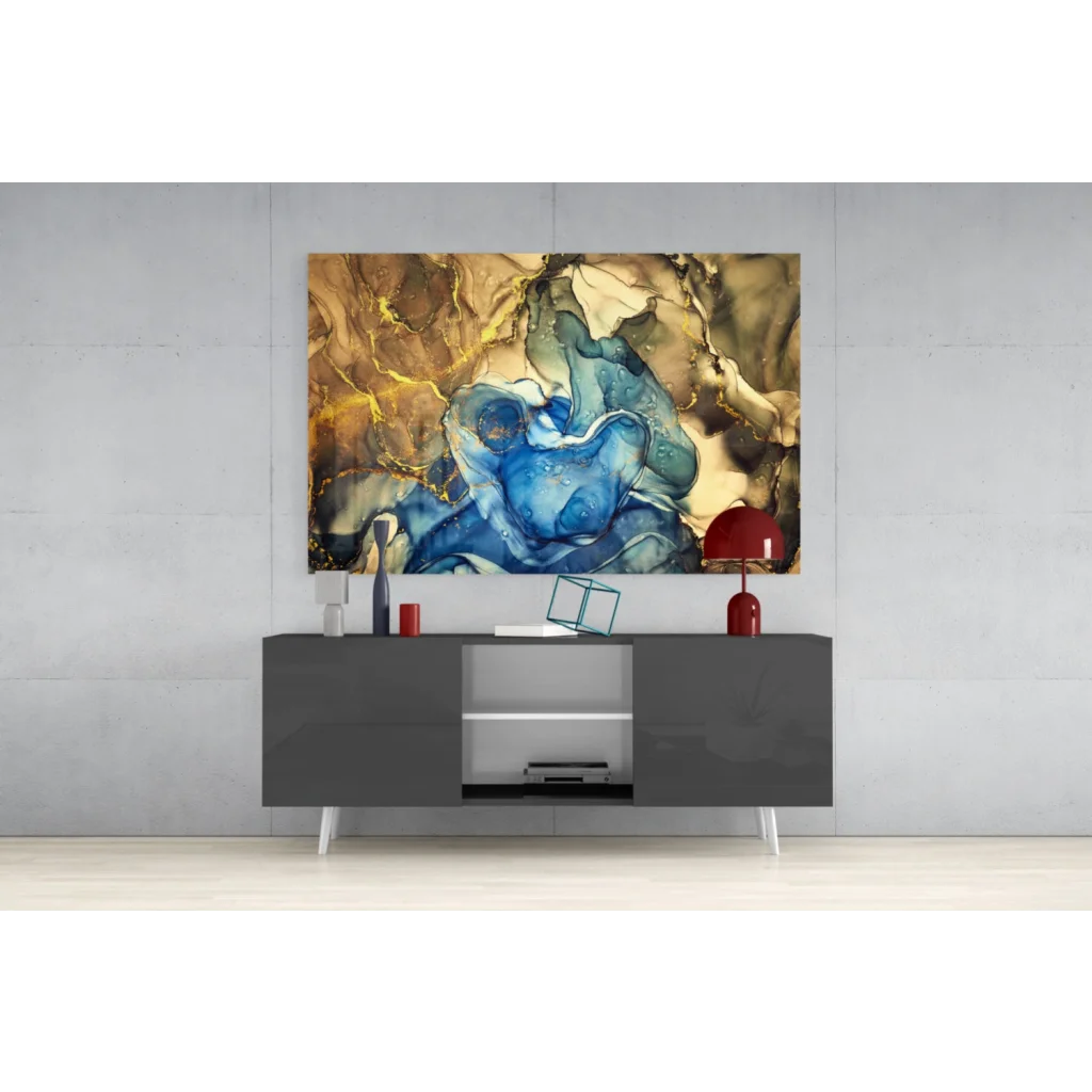 Vibrant glass wall art of swirling blue gold marbled patterns above gray console