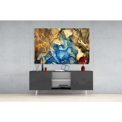 Vibrant glass wall art of swirling blue gold marbled patterns above gray console