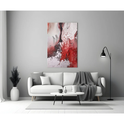 Bold red swirl glass wall art with glitter accents above modern sofa
