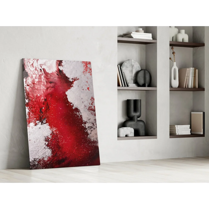 Vibrant red abstract glass wall art with textured splashes on minimalist wall