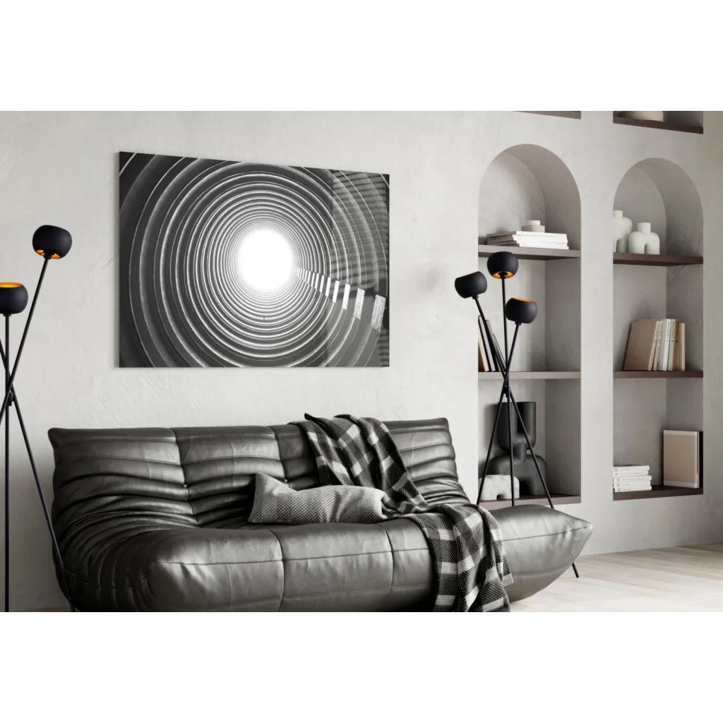 Black leather sofa with plaid throw and concentric circles wall art