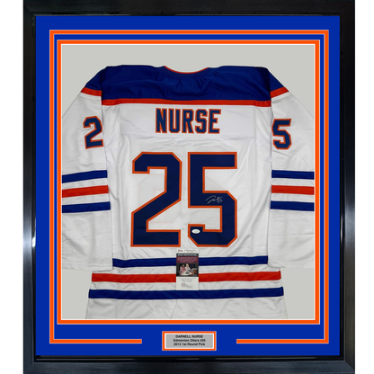 Framed white Edmonton Oilers hockey jersey number 25 with "NURSE" nameplate, navy and red stripes, displayed against blue matting with JSA authentication certificate.