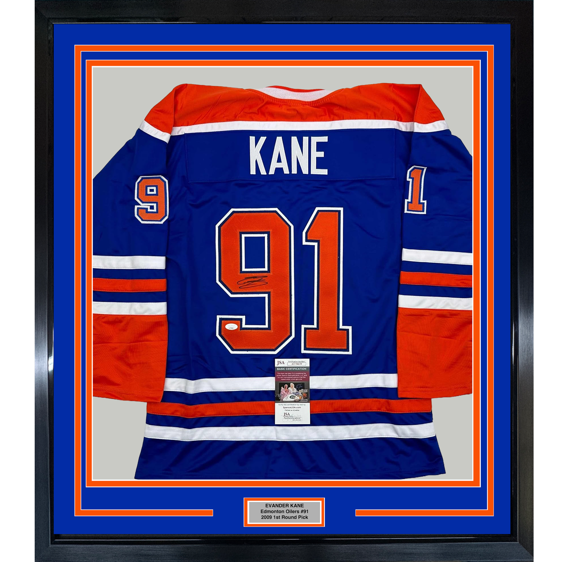 Framed Edmonton Oilers blue hockey jersey #91 with "KANE" nameplate and signature, displayed against blue and orange matting with JSA authentication certificate visible at center bottom.