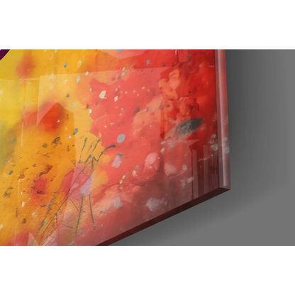 Vibrant abstract glass wall art with bold reds, yellows, and paint splatters