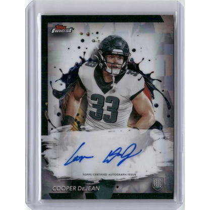 Football trading card of Cooper DeJean in white jersey with autograph and Rookie Card logo