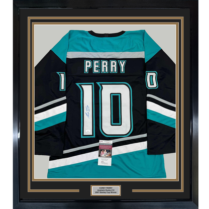 Framed black, teal, and white Anaheim Ducks #10 Perry hockey jersey with signature and JSA authentication certificate displayed flat against white mat backing.