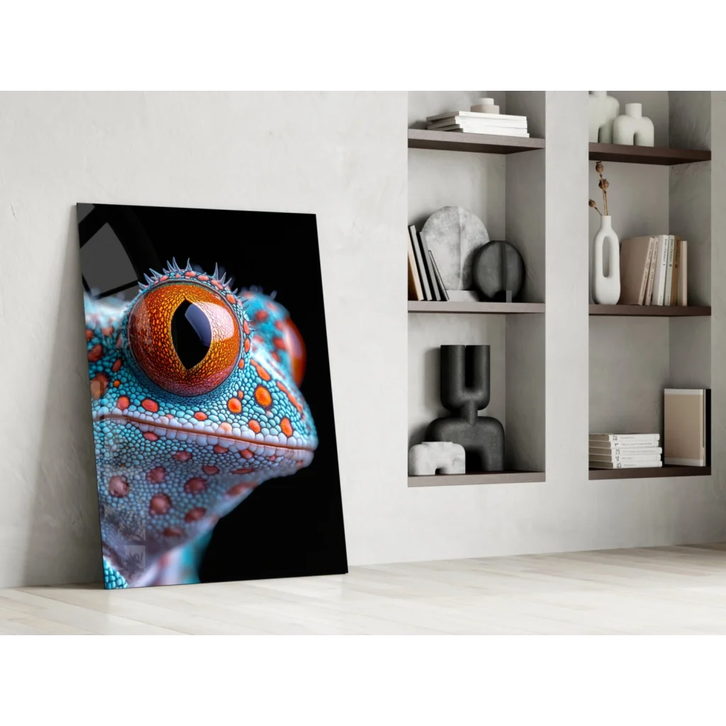Vibrant turquoise orange gecko eye glass wall art leaning on white wall
