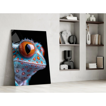 Vibrant turquoise orange gecko eye glass wall art leaning on white wall