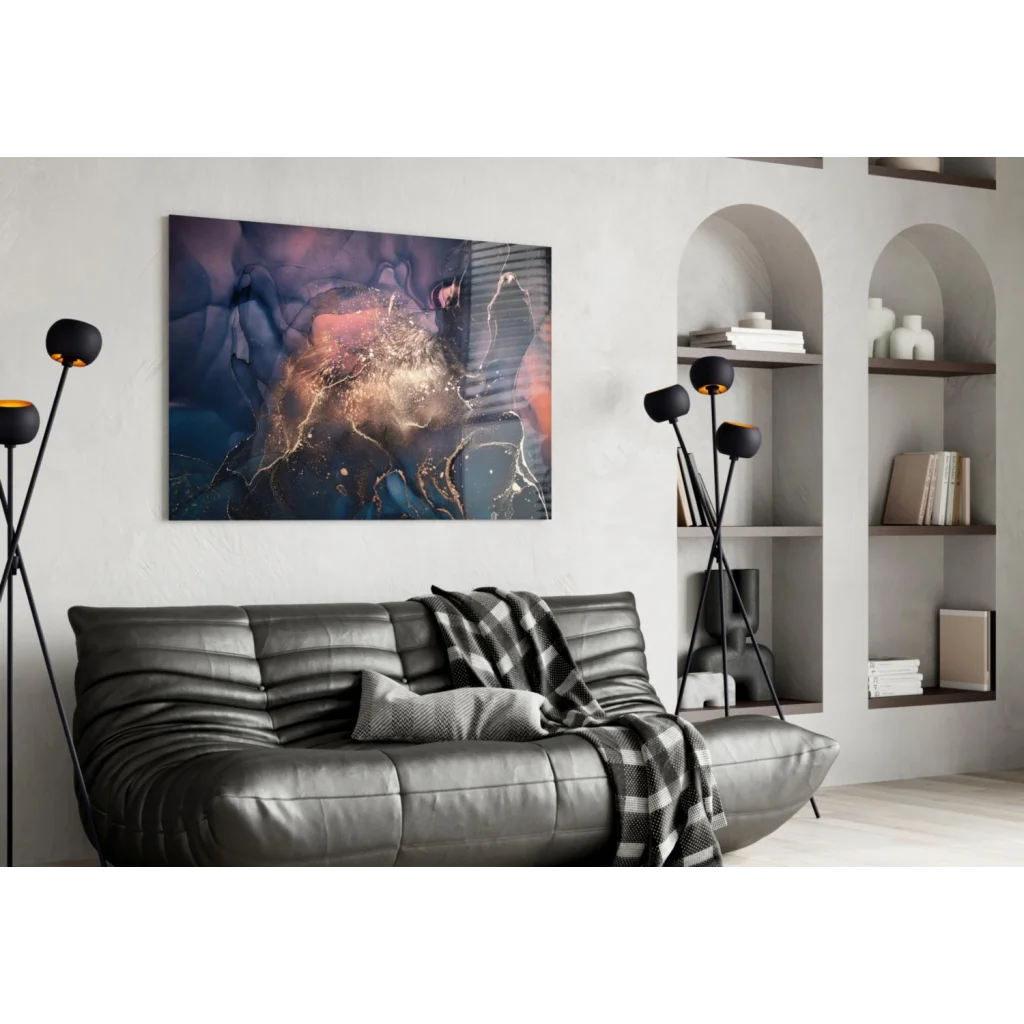 Black leather couch with plaid blanket under cosmic galaxy wall art