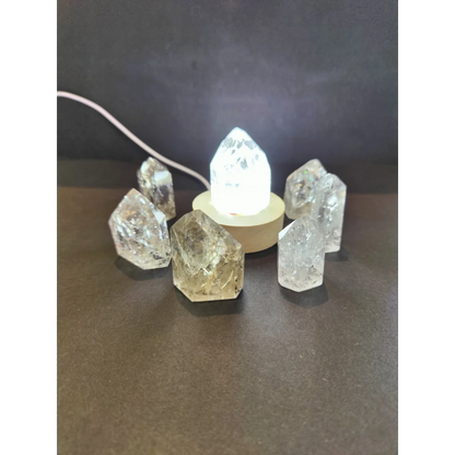 Clear quartz crackle quartz point cluster with central illuminated base showcasing natural translucent crystals