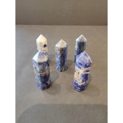 Five sodalite crystal cut base tower sculptures in blue-white marble