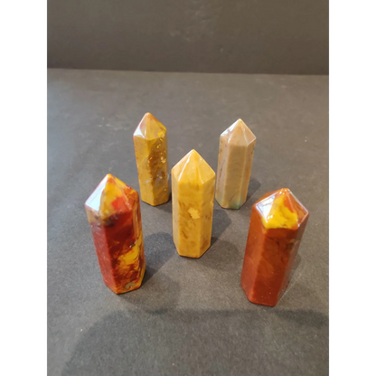 Five vibrant crystal cut base tower sculptures in yellow, orange, red hues