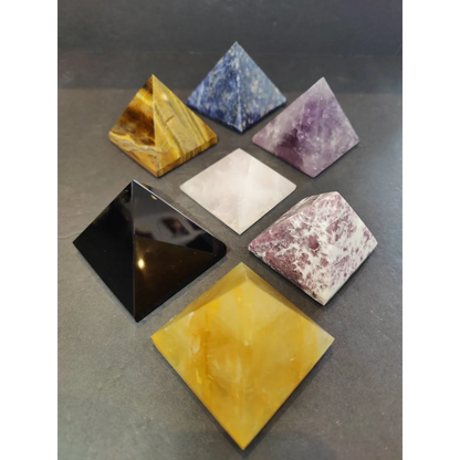 Set of six crystal polished pyramid sculptures in tiger eye, sodalite, amethyst, quartz, obsidian, and citrine colors