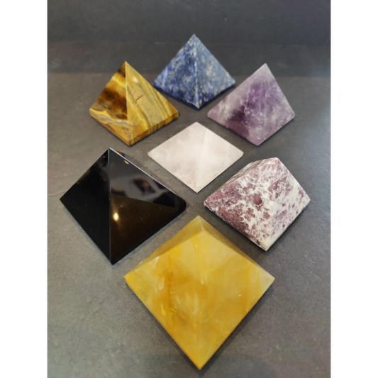 Set of six crystal polished pyramid sculptures in tiger eye, sodalite, amethyst, quartz, obsidian, and citrine colors