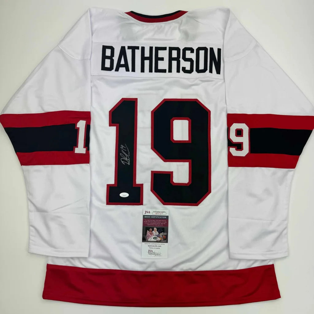 White custom hockey jersey with red and black stripes and number 19 from BATHERSon sports league