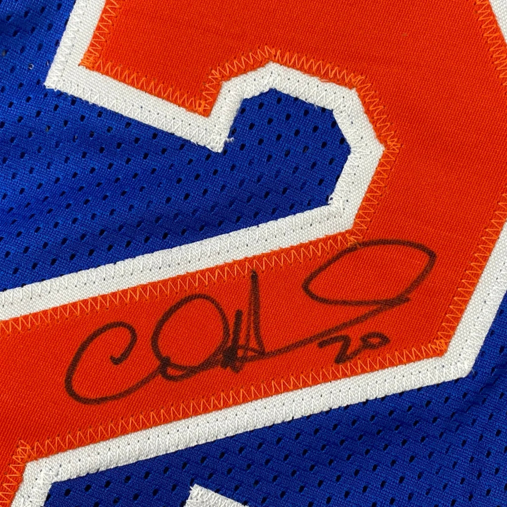 Autographed blue and orange custom jersey from professional sports league featuring Allan Houston
