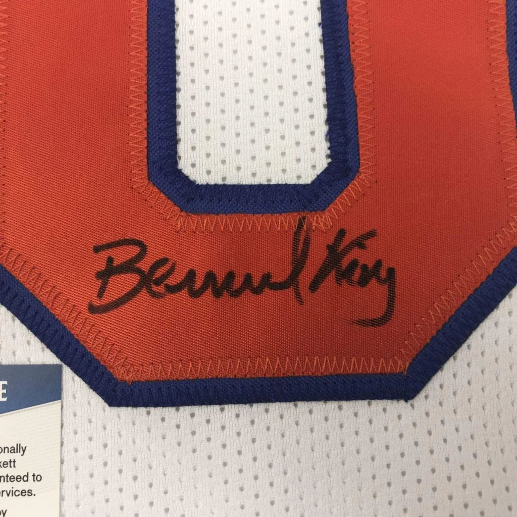 Autographed white and orange custom jersey from professional sports league featuring Bernard King