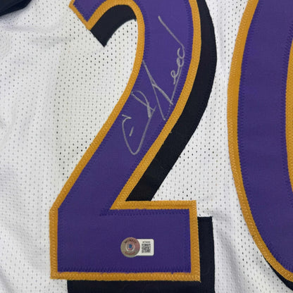Autographed white custom jersey with purple and gold numbers for professional sports fans