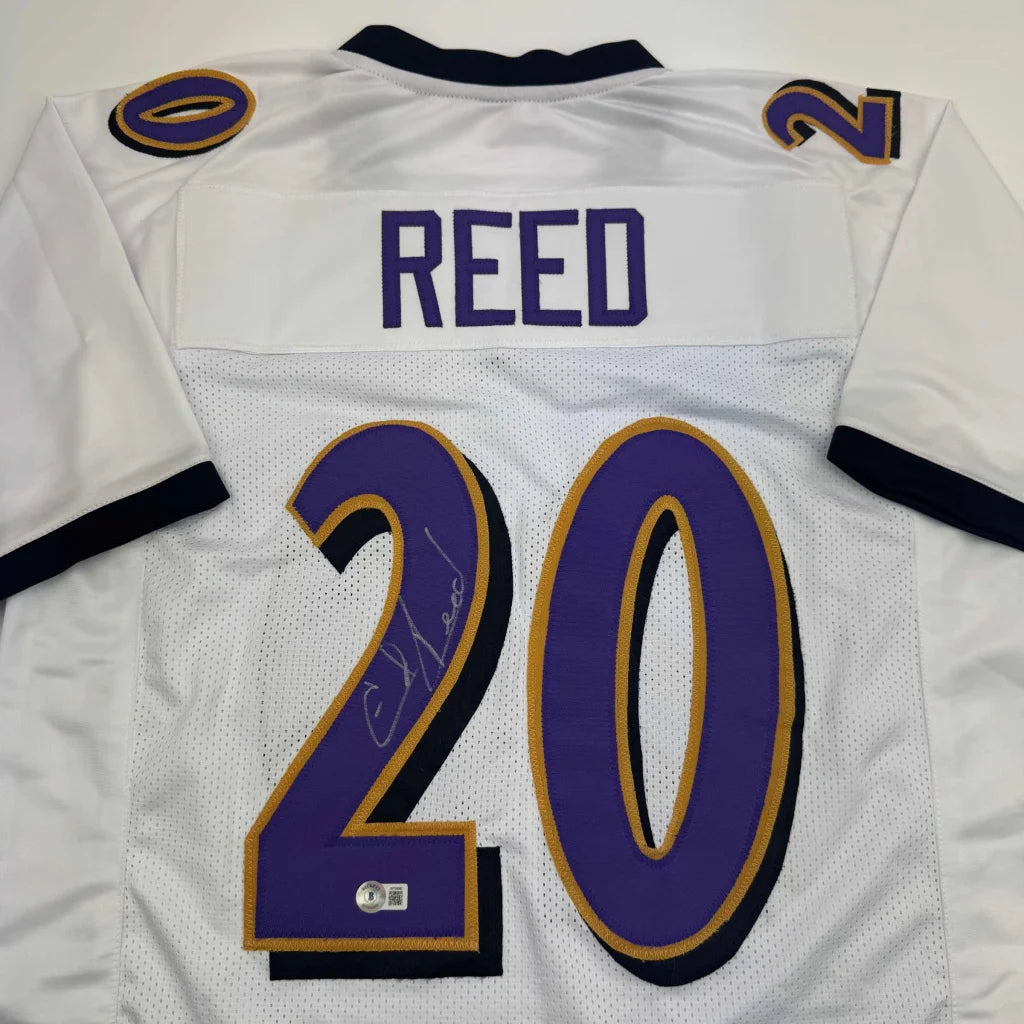 White custom jersey with purple numbers signed by C Reed for sports league fans