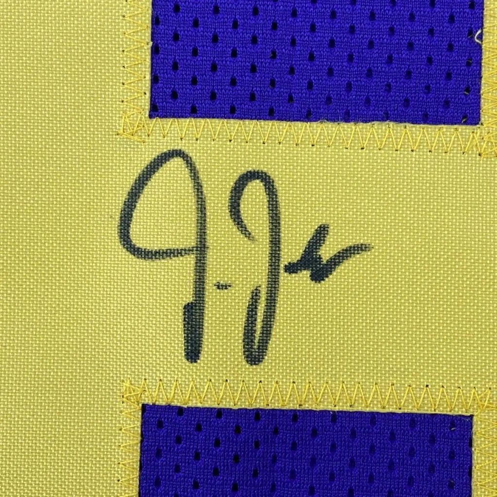 Yellow fabric with black autograph and purple mesh accents on a custom jersey for professional sports