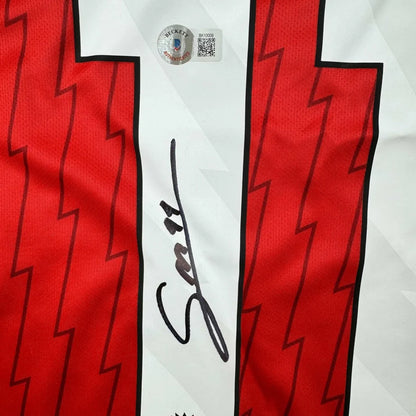 Red and white custom jersey with autograph and authentication sticker from Arsenal soccer team