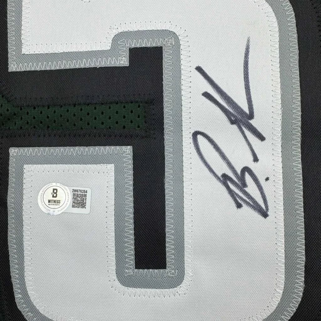 Autographed green football custom jersey with number 5 from a pro sports league