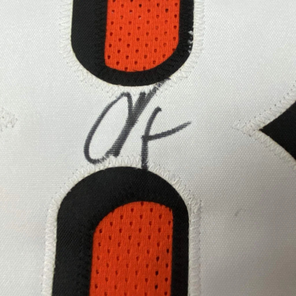 White custom jersey with orange and black numbers and autograph from C Johnson in professional sports league