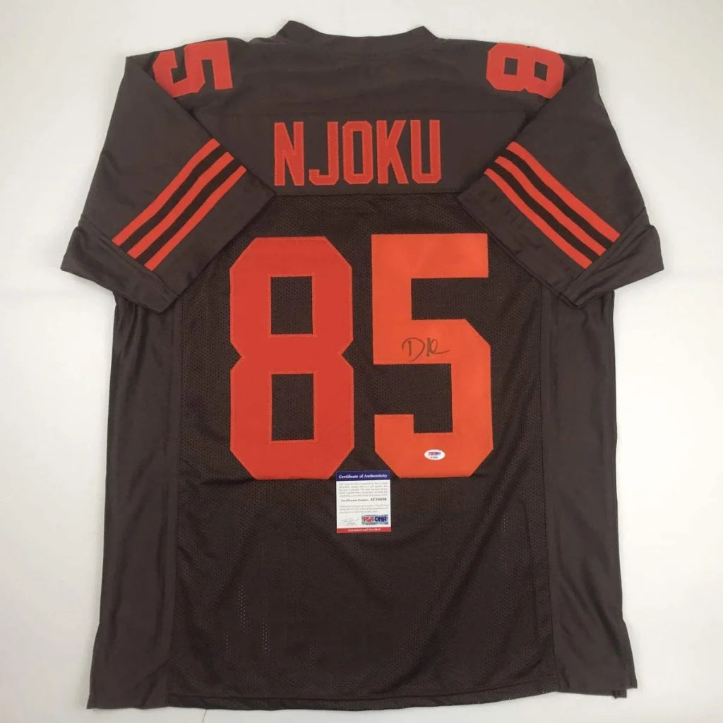 Dark brown custom football jersey with orange numbers, perfect for sports league fans