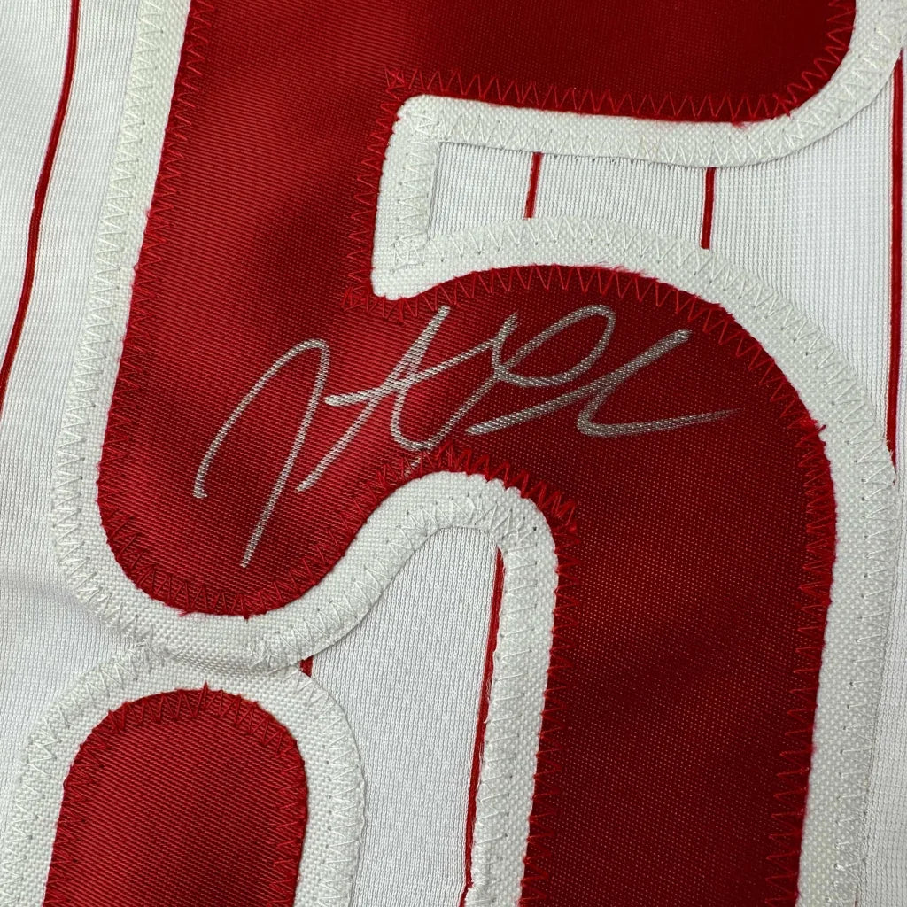 Red and white pinstriped custom jersey with silver autograph from professional sports league