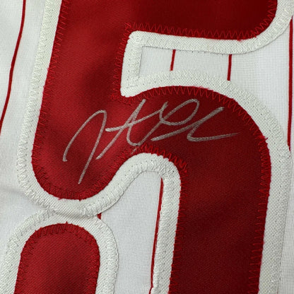 Red and white pinstriped custom jersey with silver autograph from professional sports league