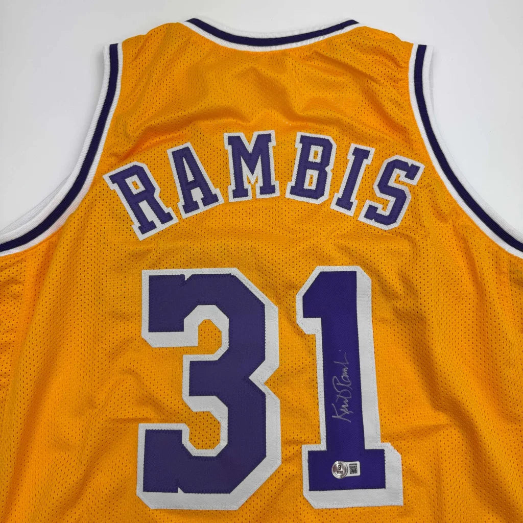 Autographed yellow purple Rambis Lakers jersey by Phil Jackson