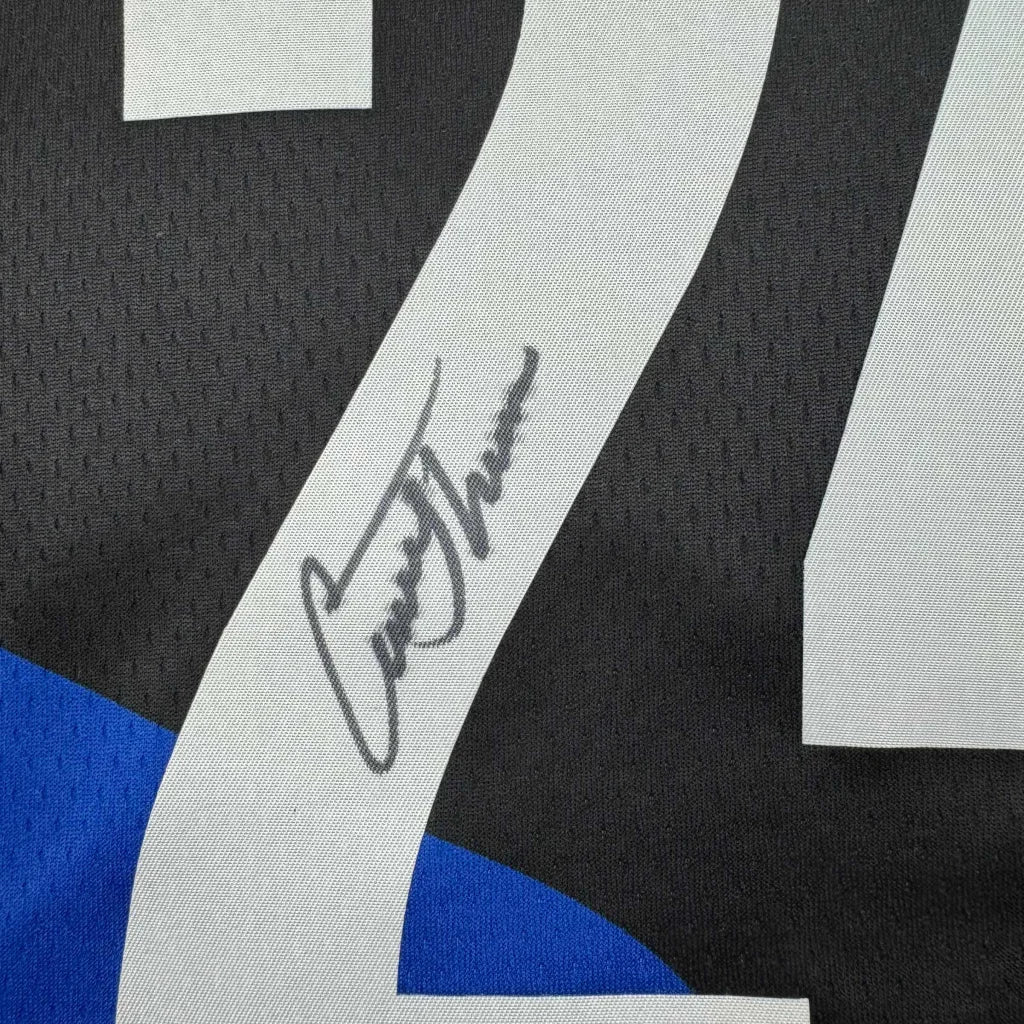 Black and white custom jersey with blue accents, signed by Larry Johnson
