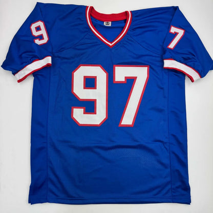 Custom blue NFL jersey with 97, signed by Carl Eller
