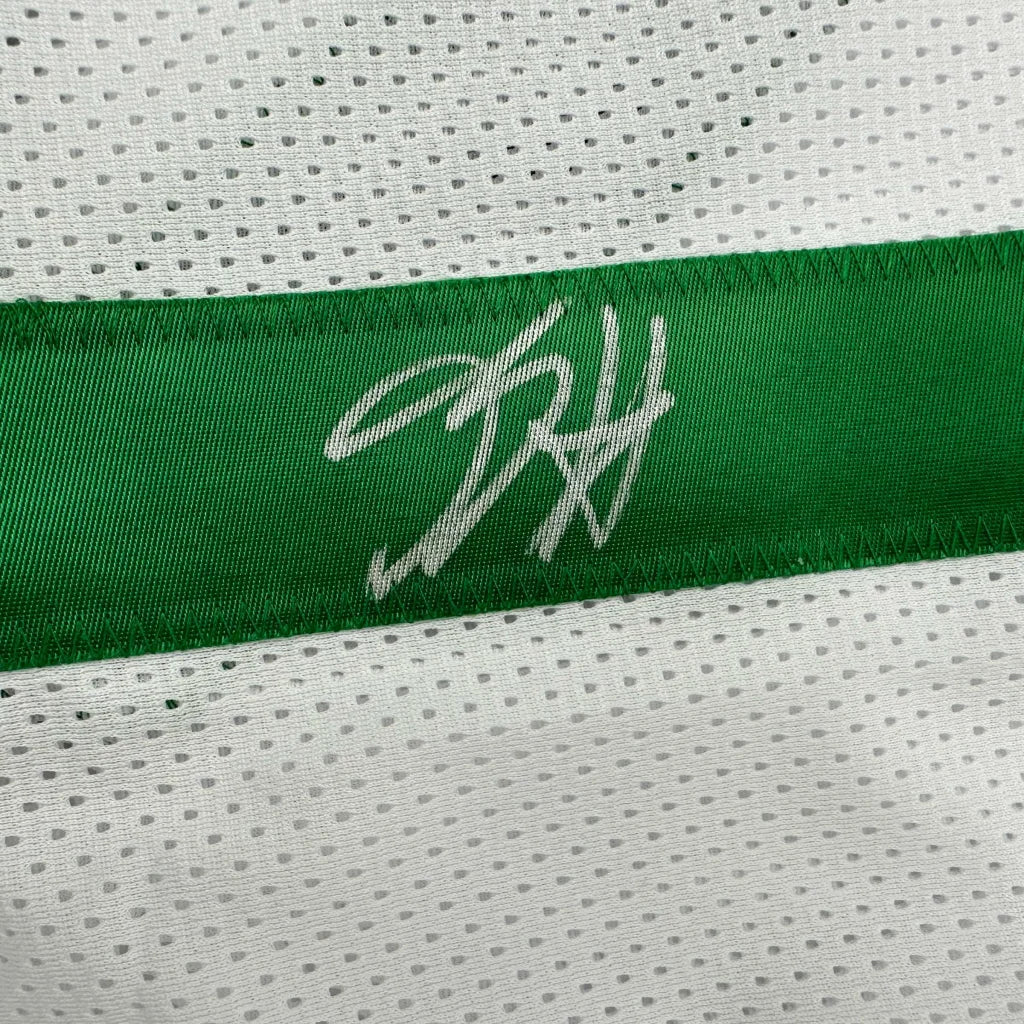White and green custom basketball jersey with signature, perfect for professional sports fans