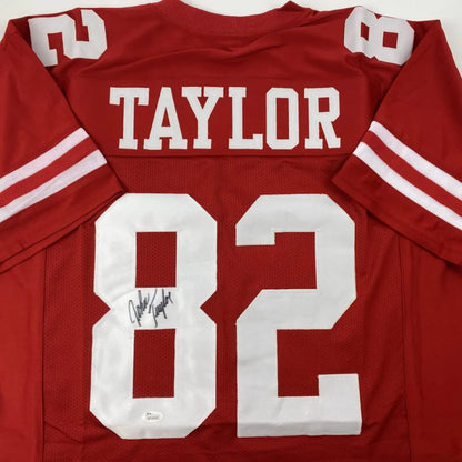 Autographed red custom jersey from a professional sports league showing player signature