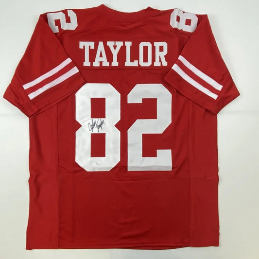 Autographed red custom jersey with TAYLOR 82 for football fans and pro sports collectors