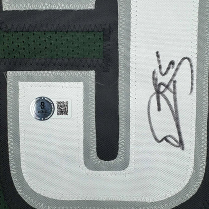 Green custom sports jersey with white and gray lettering and autograph, perfect for sports league fans