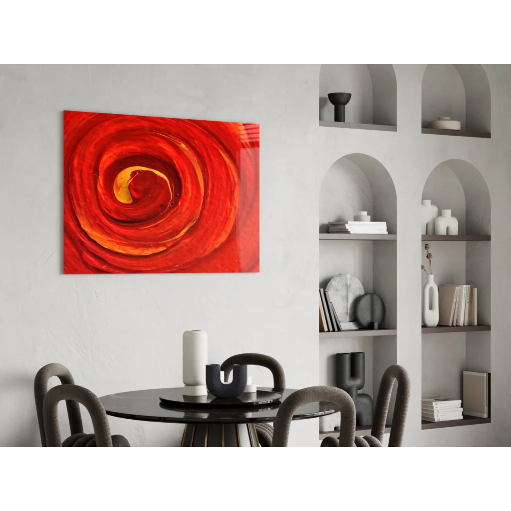 Fiery spiral glass wall art with vibrant red orange abstract swirls on white wall