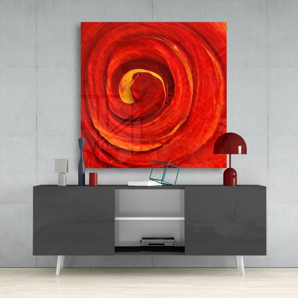 Fiery swirl glass wall art with vibrant red orange marble design on gray wall