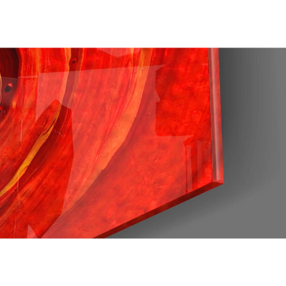 Vibrant fiery spiral glass wall art with glossy red orange swirls
