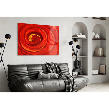 Fiery spiral glass wall art with vibrant red orange swirls above black sofa
