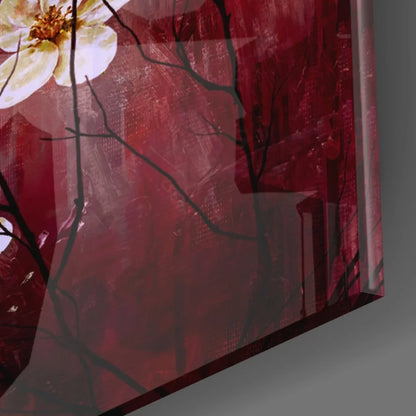 Glossy red glass wall art print of white flower with yellow center and black branches