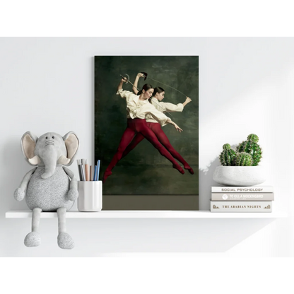 Soft gray elephant plush toy with white trunk on shelf, red dancers wall art print