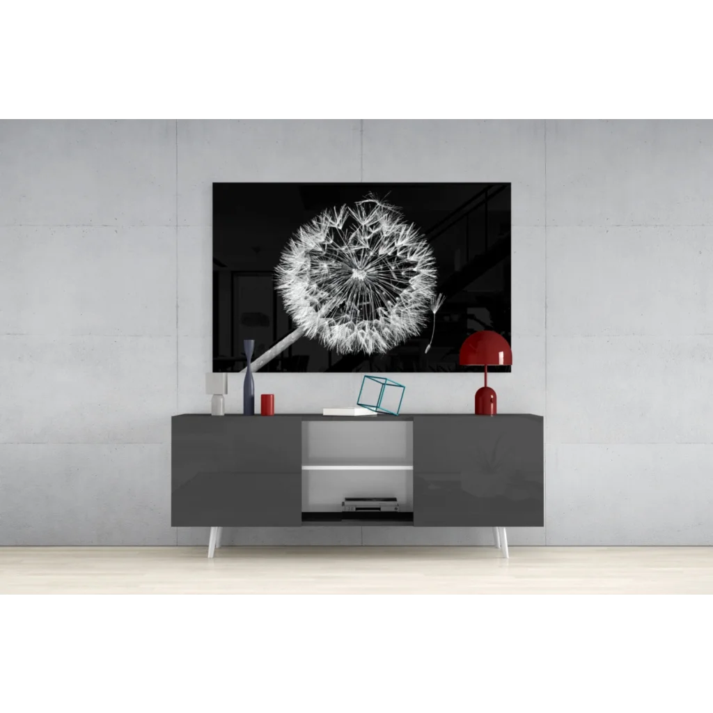 Black-and-white dandelion glass wall art framed above gray console