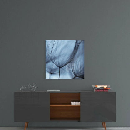 Blue-toned glass wall art of wispy dandelion stems in abstract fan design