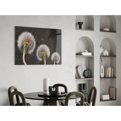 Black-framed glass wall art of three dandelion seed heads