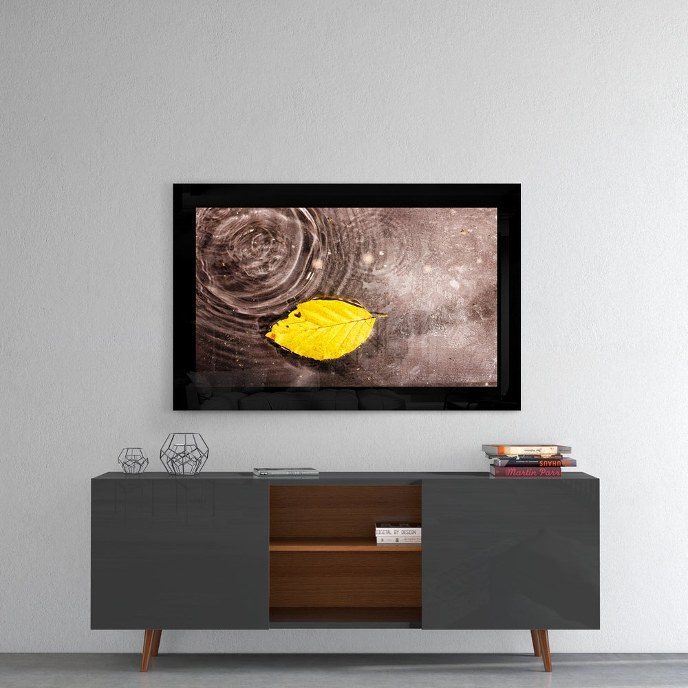 Yellow Leaf Floating On Rain Ripples Glass Wall Art