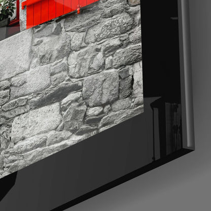 Angled view of framed stone brick texture wall art with red entrance gate visible at top edge.
