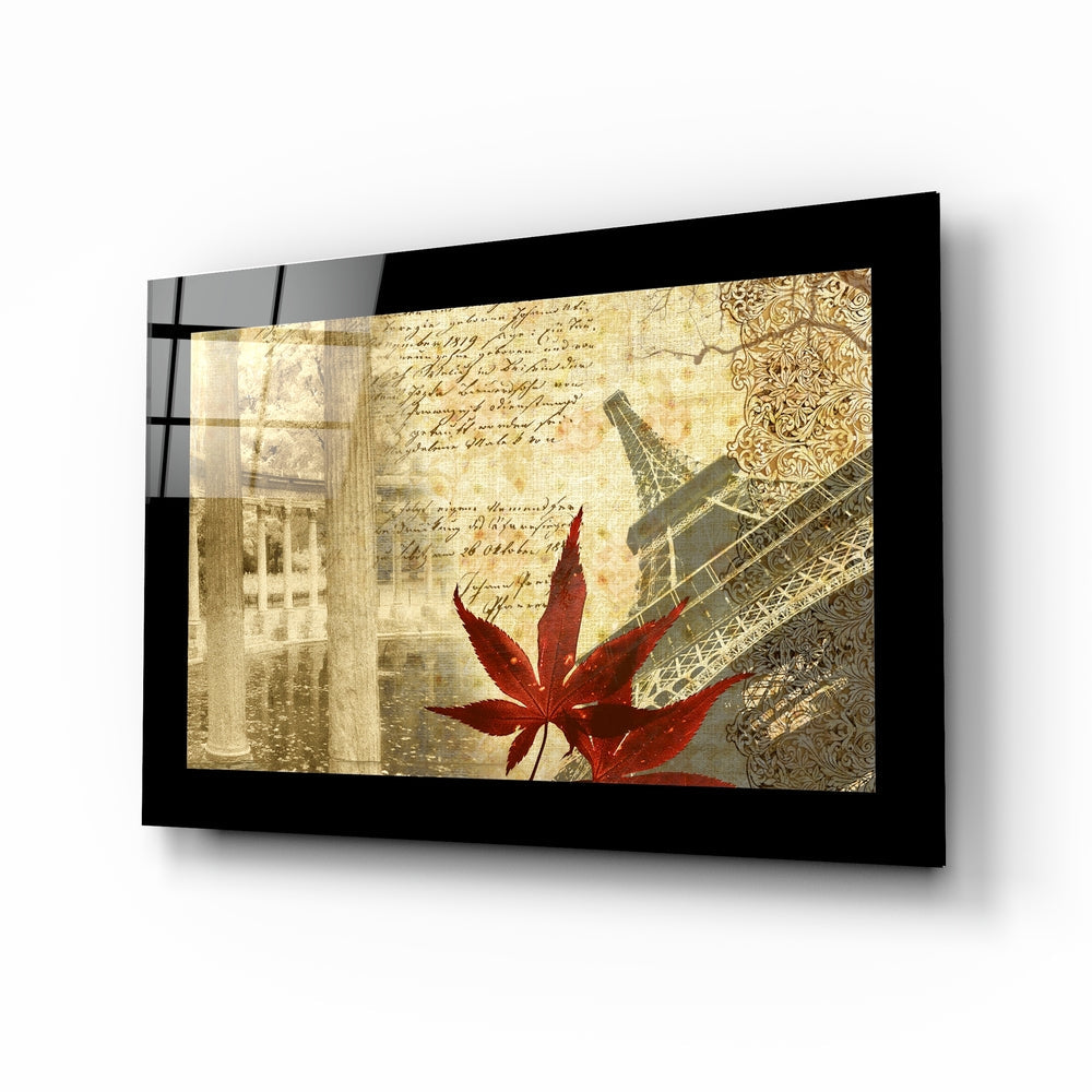 Black-framed glass wall art displaying vintage Paris collage with red maple leaf, Eiffel Tower, and sepia-toned architectural elements.